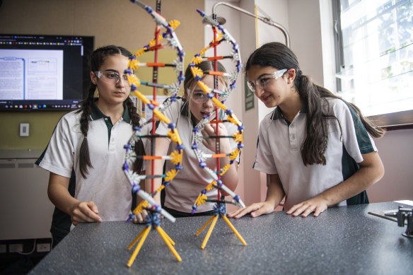 Year 8 students at St Ursula's Kingsgrove, Sienna Ferreira, Jasmine Schmidtke and Theresia Eid, during a science lesson.