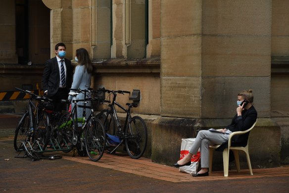 People wait for a COVID-19 test at the Sydney Eye Hospital testing site. 