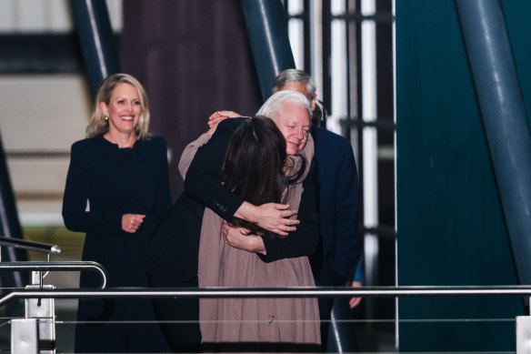 Julian Assange hugs wife Stella as lawyer Jennifer Robinson looks on.