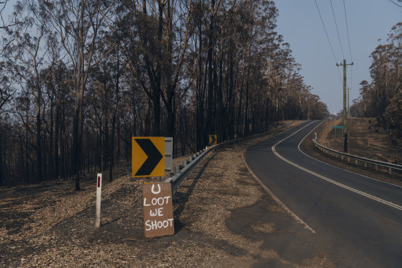 A sign reading "U Loot We Shoot" on Lake Conjola Entrance Road.