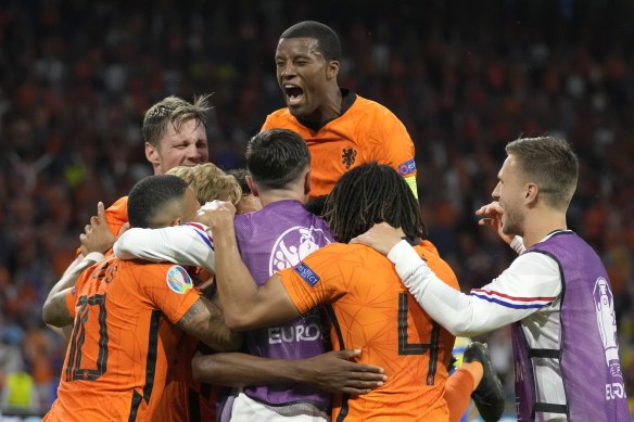 Netherlands players celebrate after Denzel Dumfries’ late winner.