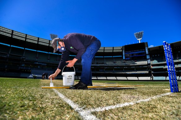 MCG curator Matt Page repaints the MCG lines on Monday.