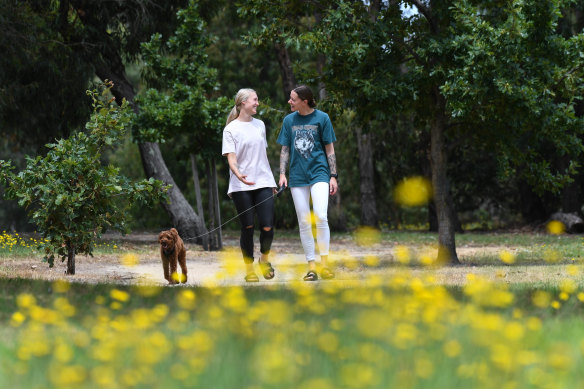 St Kilda teammates and partners Bianca Jakobsson (right) and Darcy Guttridge with Harry the dog. 