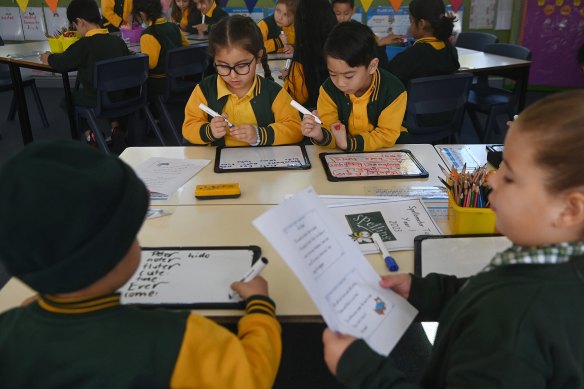 NSW introduced a new syllabus in 2022 that mandated the use of phonics. Students at Fairfield West Public School are pictured here learning phonics last year.