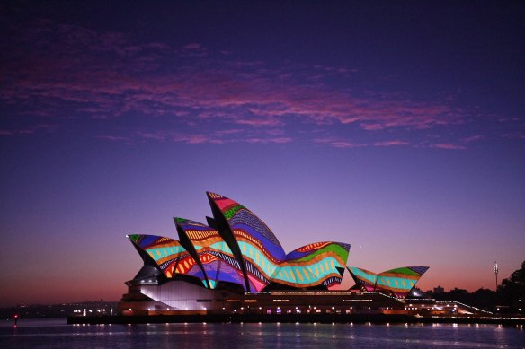 An Indigenous image is projected onto the Sydney Opera House at dawn on January 26. 