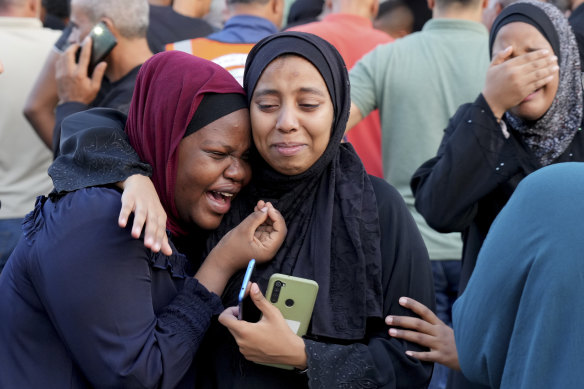 Distraught Palestinians outside a hospital in Deir Al-Balah, in the southern Gaza Strip.