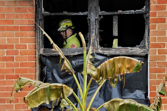 NSW Fire and Rescue investigate inside the burnt-out home in Lalor Park.