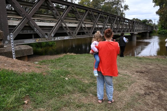 Residents watch the water rising at Forbes on Monday.