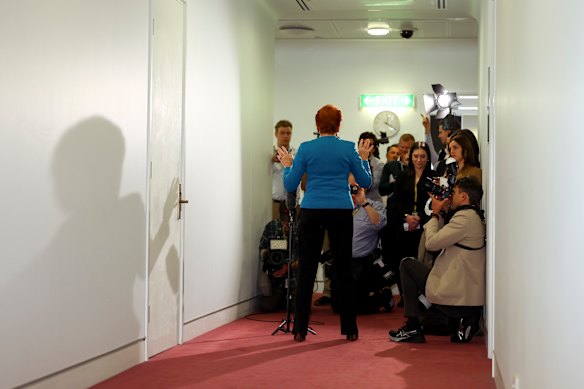 Pauline Hanson casts a long shadow in front of the press.