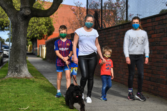 Amity Smith heads on a masked family walk with her children.