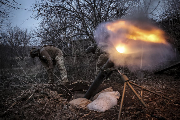 Ukrainian soldiers fire a mortar towards Russian army positions near Chasiv Yar, in the Donetsk region, on Sunday.
