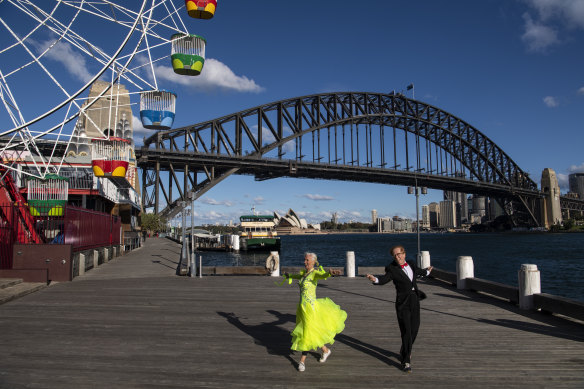 Roger Selby and Sue Johnson practising ballroom dance moves while social distancing at Milsons Point. 