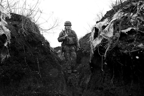 A Ukrainian soldier with the 30th Brigade stands in the trenches on the front line in the Donbas region.