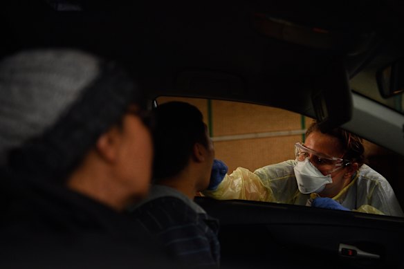 Registered nurse Ashlee Jackson performs a COVID-19 test on a man in Summer Hill on Tuesday.