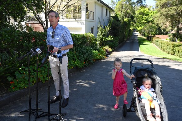 Dominic Perrottet with daughters Harriet and Beatrice outside their Beecroft home on Sunday.