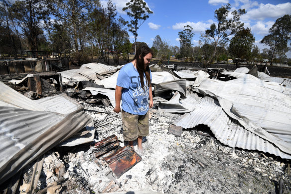 Liam McKenzie inspects the remains of his house, destroyed by bushfires in Rappville, in northern NSW.
