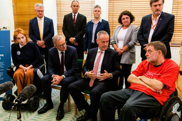 Labor leader Anthony Albanese and spokesman on the NDIS Bill Shorten speak with disabilities representatives to about the scheme in late March.