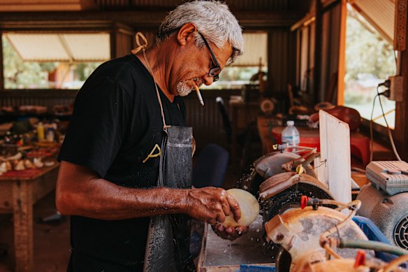 Sibosado in his shed preparing mother-of-pearl shell for ceremonial etching.