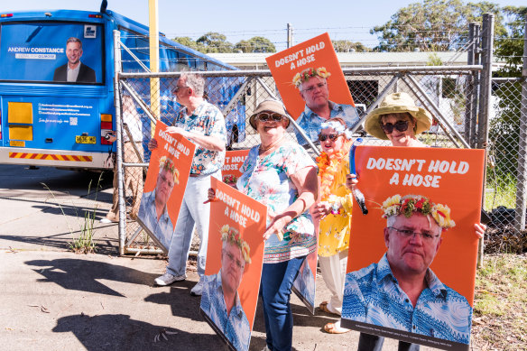 Anti-Morrison protesters – wearing Hawaiian shirts – outside the East Coast Canning factory on Monday.