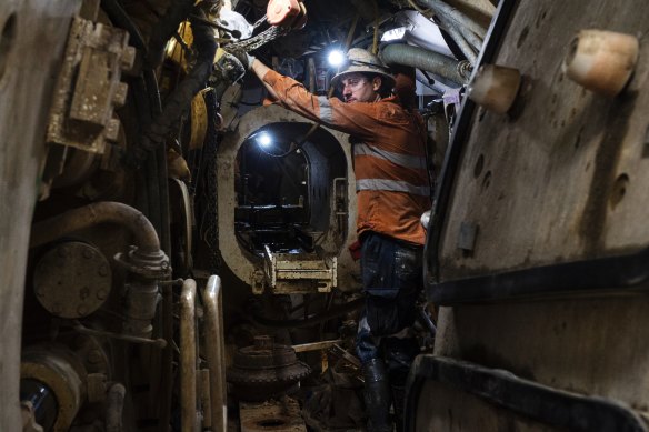 A worker operates the tunnel boring machine known as Kathleen, deep below Sydney Harbour.