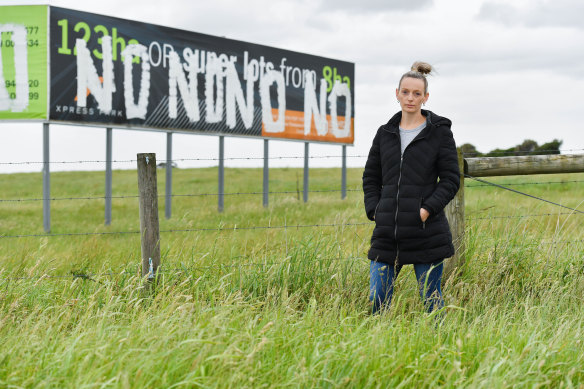 Resident Katherine Mann in front of a large Cranbourne West piece of farmland at the centre of the IBAC hearing this week.