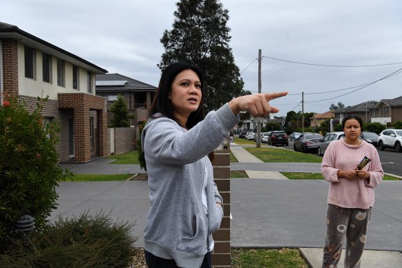 Neighbours Irada Tahpa, left, and Richielle discuss the events of Wednesday night. 