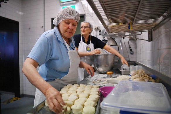 CWA volunteers Jenny Le Gros (left) and Diana Whitton bake scones at the Sydney Royal Easter Show.