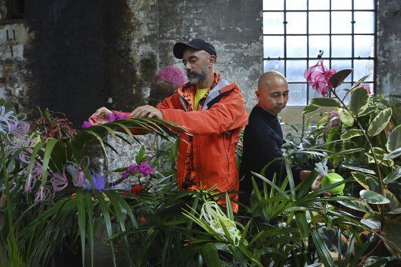 Luke George (left) and Daniel Kok (right) among plants in their Hundreds and Thousands work.