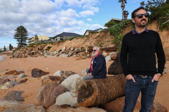 Coastal engineer Angus Gordon (seated) and UNSW researcher Mitchell Harley assess the impacts of the recent storms on Narrabeen on Sydney's northern beaches.