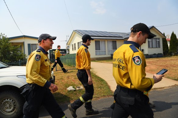 Former prime minister Tony Abbott (left) with the Davidson 1 RFS crew arriving at Adaminaby RFS station on Friday.