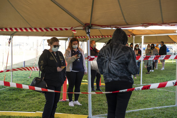 Teachers from the Fairfield local government area queue for their vaccinations in July.