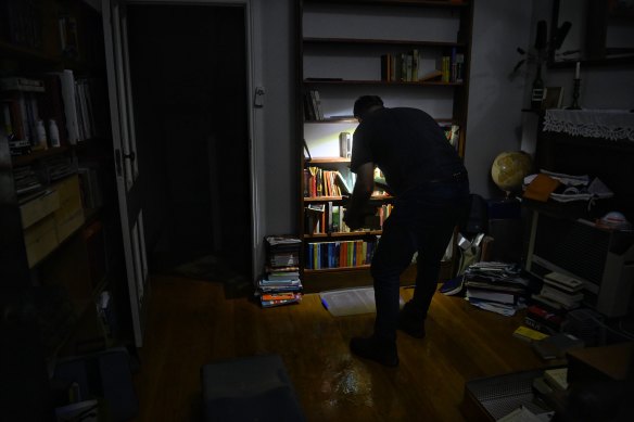 Ben Sullivan of Windsor packing his house as his ground floor floods on Sunday night.