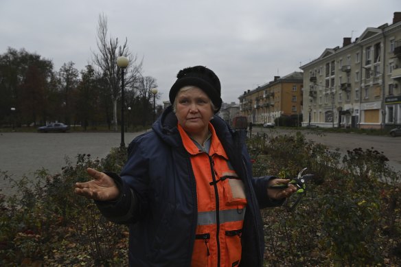 Council worker Kateryna, 69, works on a garden in the centre of town.
