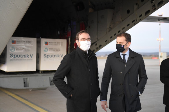 Slovak Prime Minister Igor Matovic, right, and Health Minister Marek Krajci oversee the arrival of a shipment of the Russian vaccine Sputnik V into Slovakia.