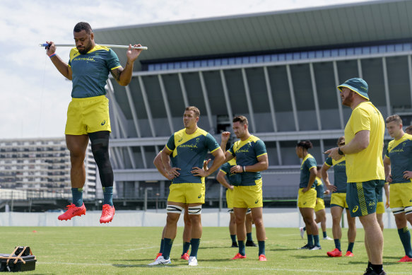 Australia’s Samu Kerevi, left, jumps during a warm up at a men’s rugby sevens practice in Tokyo.