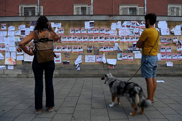 People look at the posters of Israeli hostages taken by Hamas on October 7 in Tel Aviv, Israel.