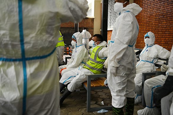 Officials work to identify bodies at the Maharajgunj Medical Campus.