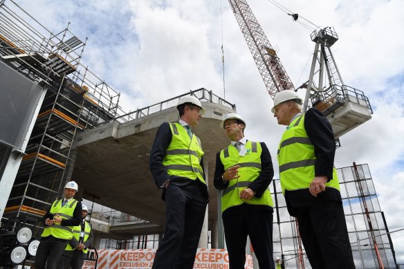 Former NSW Premier Dominic Perrottet (3rd from left) and Lang Walker (right) attending a topping out ceremony at Parramatta Square in 2021.