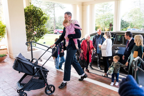 Minister for  Home Affairs and Cyber Security Clare O’Neil (back left) and Treasurer Jim Chalmers (back right) arrive at Government House with their families. 