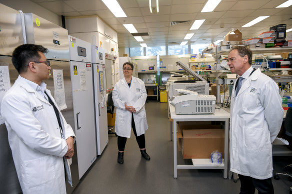 The Minister for Health, Greg Hunt, Associate Professor Mireille Lahoud and Professor Allen Cheng at the Monash Biomedicine Discovery Institute.