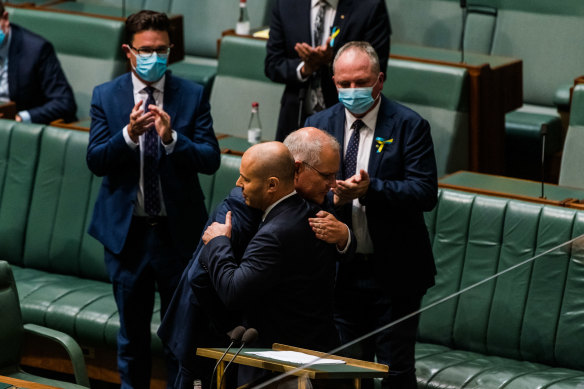 Et tu, Scomo? Scott Morrison embraces former treasurer Josh Frydenberg in March. Frydenberg was not told that Morrison had also sworn himself in as treasurer.