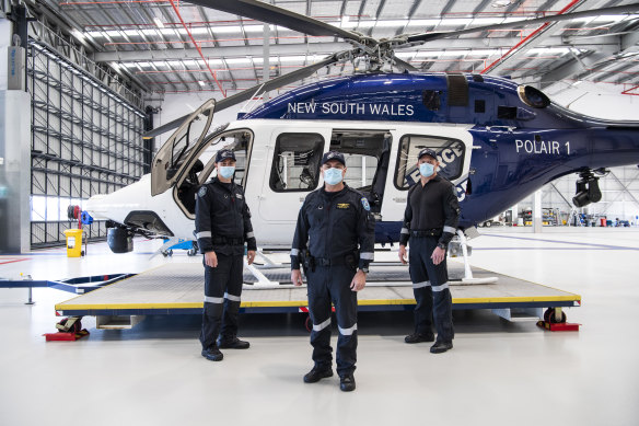 PolAir pilot, Senior Constable Jonathan Smith, aviation commander, Special Constable Kevin Drake, and  crewman, Senior Constable Rod Rankin after locating three-year-old Anthony Elfalak. 