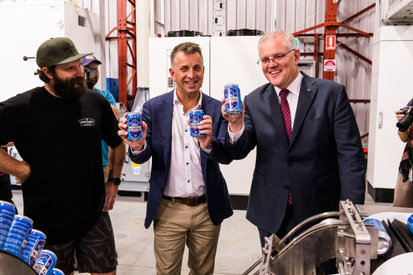 East Coast Canning owner Chris Kelly with candidate for Gilmore Andrew Constance and Prime Minister Scott Morrison holding their special federal election beer cans.