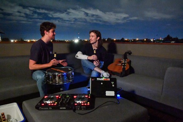 Cousins Jordan Tranter (right) brought his guitar and jammed on his cousin Daniel Smith’s rooftop after midnight.