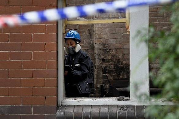 A NSW Police forensic officer inside a burnt room of the Croydon house.