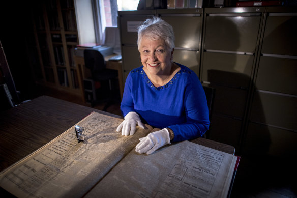 Janine Rizzetti of the Heidelberg Historical Society pores over old copies of the Heidelberg News and Diamond Creek Chronicle.