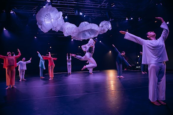 The dancers rush in and out through multiple entrances in wave after wave.