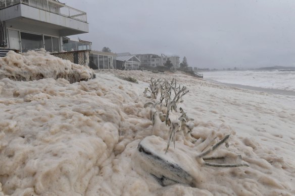 Sea foam whipped up by the strong powerful surf begins to inundate properties along Collaroy.