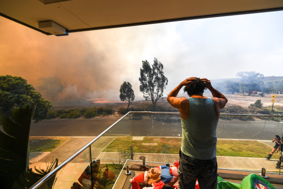 Ange Vlahopoulos watches as the fire approaches his home on Clovemont Way, Bundoora.