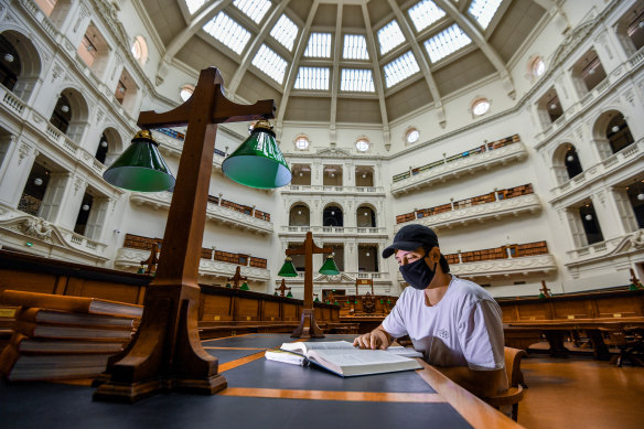 James Seymour reads under the dome in the State Library's La Trobe reading room.